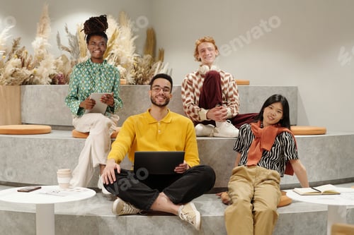 Preview: Smiling Young Adult Coworkers Collaborating in Modern Creative Workspace