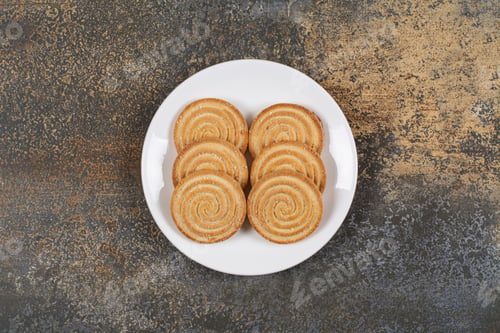 Preview: Pile of tasty round biscuits on white plate