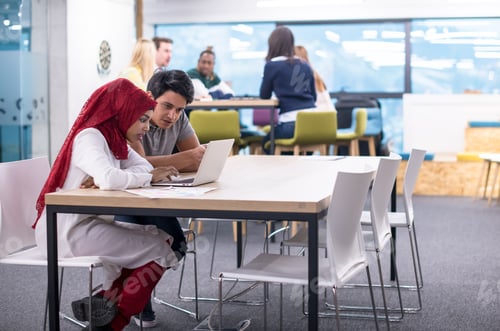 Preview: black muslim business woman having a meeting with her indian male colleague