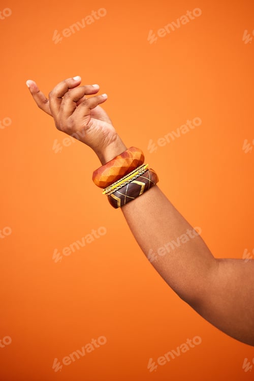 Preview: Which way are you going. Shot of an unrecognizable person pointing against an orange background.