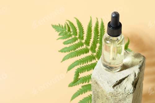 Preview: Natural cosmetic oil on natural stone with shadow tropical leaves.