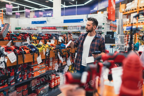 Preview: a customer in a hardware store compares two screwdrivers