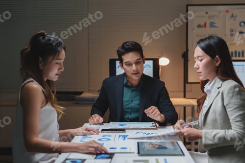 Preview: Business team analyzing financial data late night