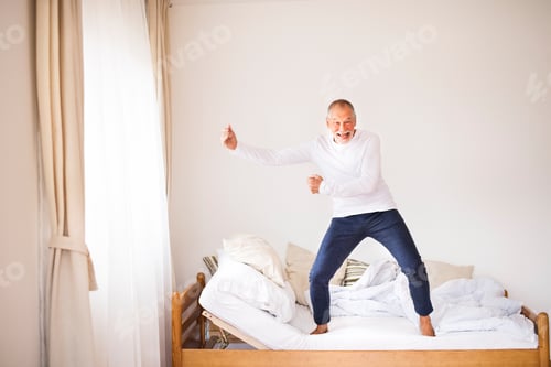 Preview: Senior man doing exercise at home.