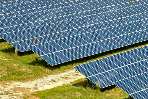 Preview: Aerial view of big sustainable electric power plant with many rows of solar photovoltaic panels
