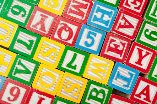 Preview: Letters background. Wooden cubes with letters on wooden background