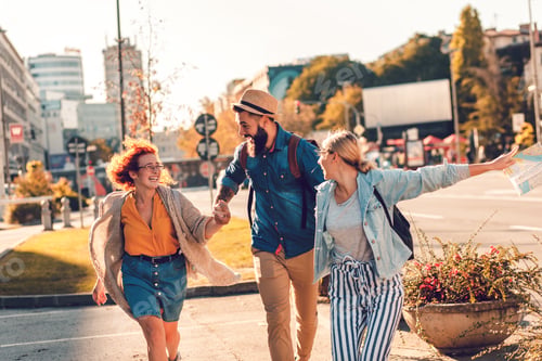 Preview: Group of tourists enjoying on vacation walking on city street.