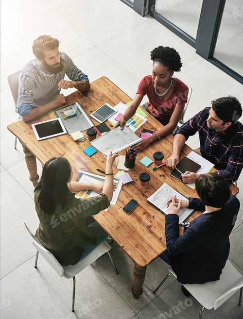 Preview: High angle shot of a group of colleagues having a meeting in a modern office