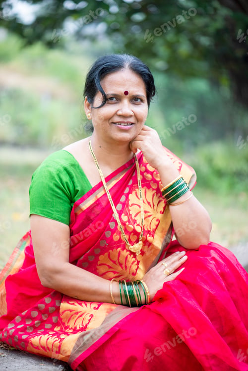 Preview: Happy Indian woman in traditional clothes at outdoor.