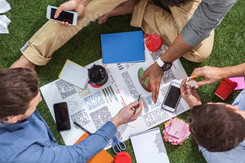Preview: overhead view of business people working on new business plan, business teamwork