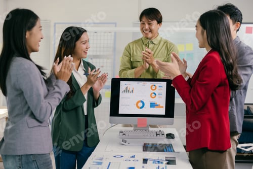 Preview: Business team clapping celebrating successful project during meeting
