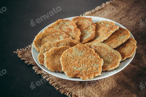 Preview: Potato pancakes on a plate and fork on linen background
