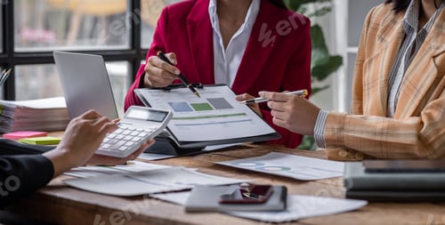 Preview: Group of confident business people point to graphs and charts to analyze market data, balance sheet,