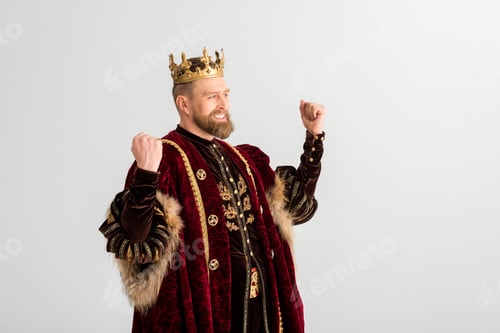 Preview: happy king with crown showing yes gesture isolated on grey