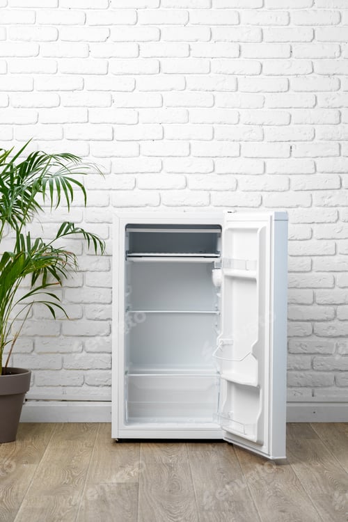 Preview: White Refrigerator With Open Door in Front of Brick Wall