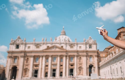 Preview: Closeup toy airplane on St. Peter's Basilica church in Vatican city background