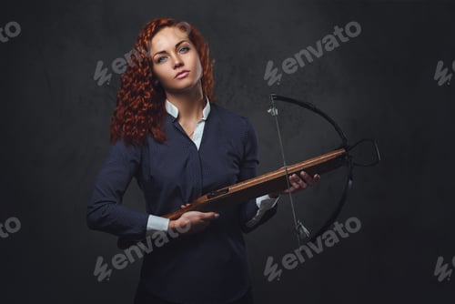 Preview: Redhead female holds crossbow.