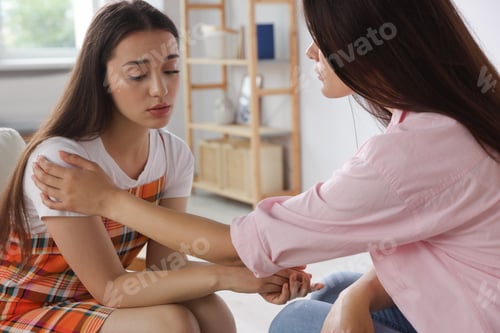 Preview: Professional psychologist working with young woman in office