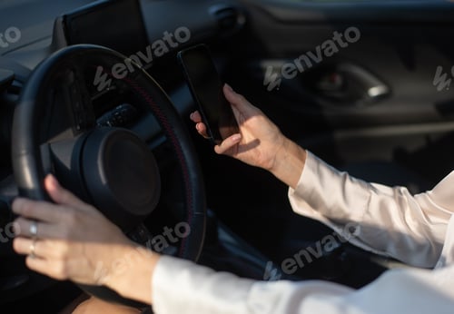 Preview: Man driving with smartphone
