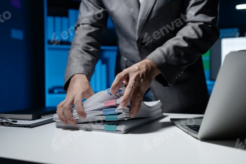 Preview: An employee held a large pile of documents in his hand, Large piles of work documents on desks are b