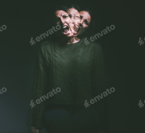 Preview: Studio shot of a young woman experiencing mental anguish and screaming against a black background