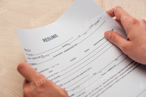 Preview: cropped view of recruiter holding resume template in hands