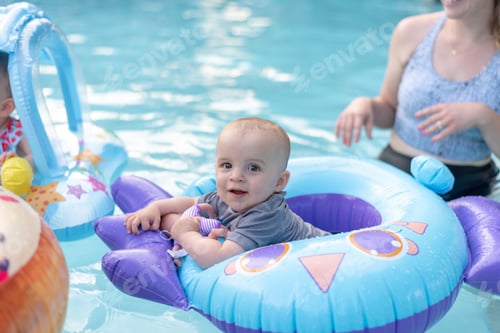 Preview: Baby boy in inflatable floatie at the swimming pool