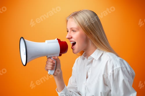 Preview: Teen girl making announcement with megaphone against orange background