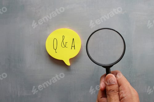 Preview: Hand holding magnifying glass and speech bubble with text Q and A