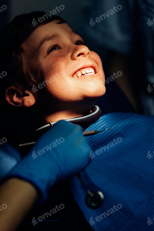 Preview: Dentists with a patient during a dental intervention to boy.