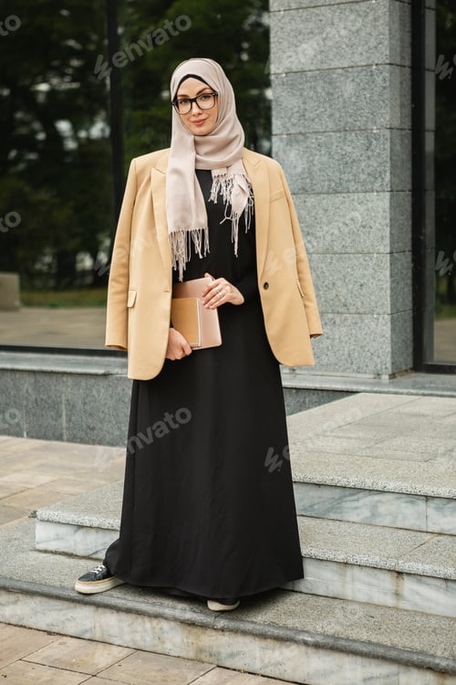Preview: modern stylish muslim woman in hijab in city street