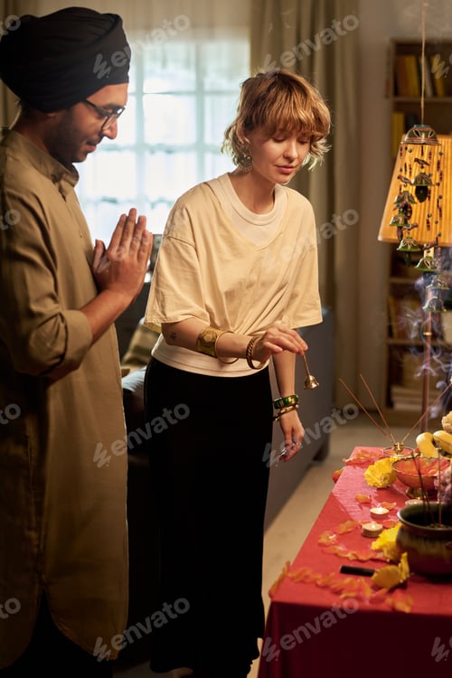 Preview: Couple Engaging in Cultural Ritual in Living Room Setting