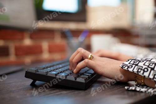 Preview: Person using keyboard on office desk