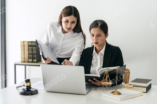 Preview: Female lawyer is holding law book and giving advice about laws a