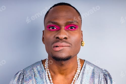 Preview: brazilian gender fluid male dressed as female with gorgeous make up in studio white background