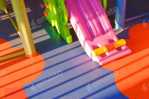 Preview: light and shadow on surface of slide and playground equipment on colorful floor in kindergarten