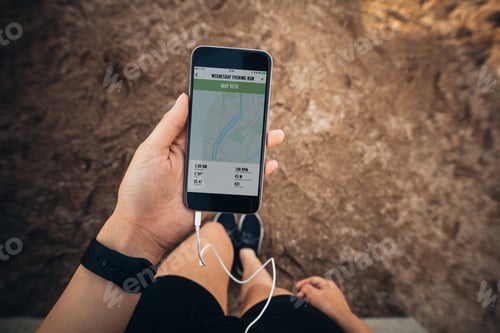 Preview: Sportswoman checking smartphone after jogging