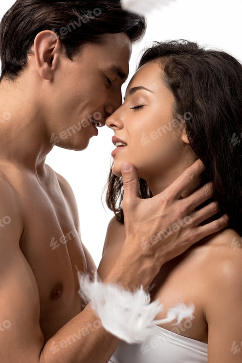 Preview: happy couple hugging and going to kiss isolated on white with feathers