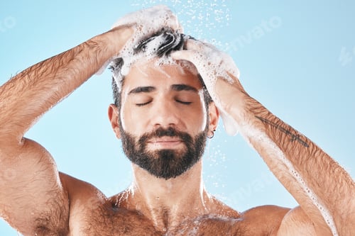 Preview: Hair care, face water splash and shower of man in studio isolated on a blue background. Water drops