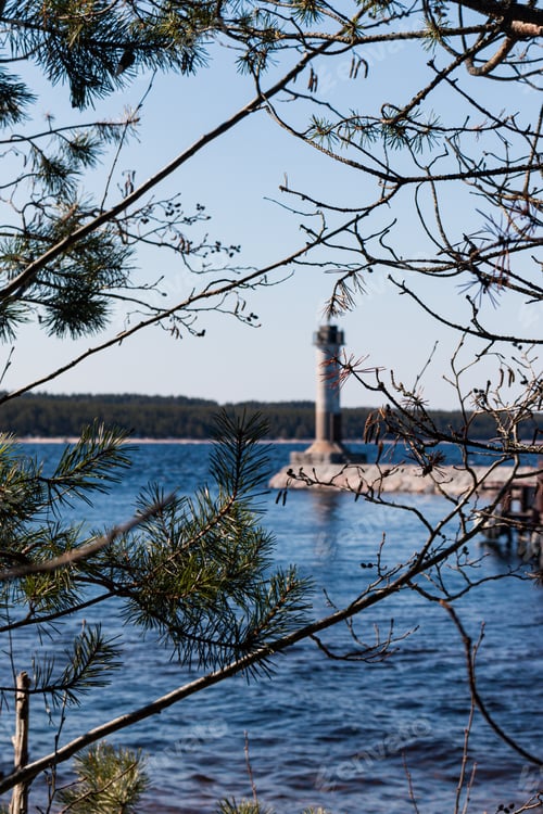 Preview: An abandoned lighthouse surrounded on all sides by blue water