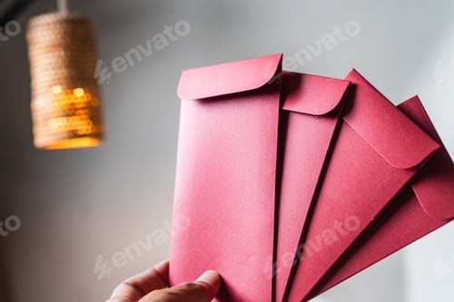 Preview: Hand Holding Red Envelopes with Pendant Light