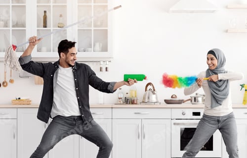 Preview: Playful middle-eastern man and woman having fun while cleaning