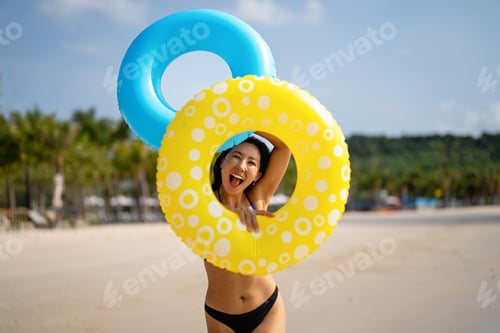 Preview: Excited young woman enjoying her tropical beach vacation and celebrating a fun-filled summer getaway