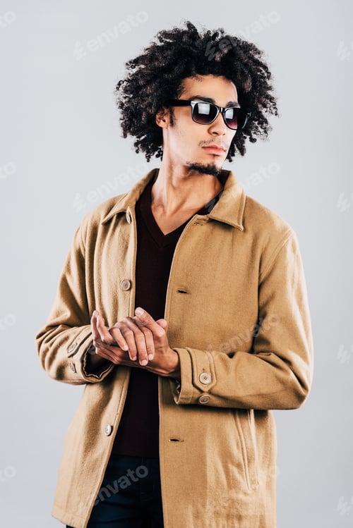 Preview: Man in Overcoat and Sunglasses in Studio