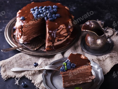 Preview: Chocolate cake from chocolate pancakes with icing, with blueberries.