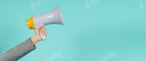 Preview: Hand is hold megaphone and wear grey suit on green or mint or Tiffany Blue background.