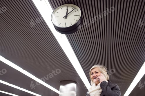Preview: Senior woman at the underground platform, talking on phone