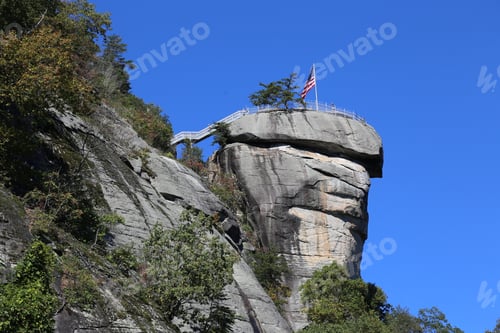 Preview: Low-angle view of the flag of the USA on the mountain