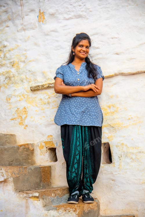Preview: Woman in front of white color traditional house, India.