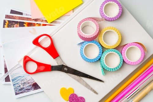 Preview: Crafting materials spread on a table for creative projects with scissors, washi tape, and colored